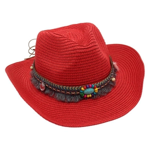 Close-up of red woven straw hat featuring ethnic beads, tassels and a turquoise stone