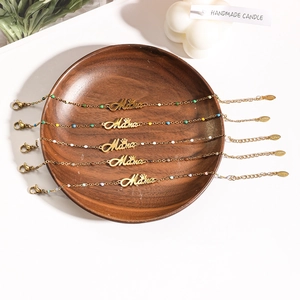 5-piece gold Mother's Day bracelet set with Mama charms and colorful beads in a wood tray