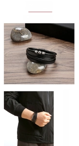 Close-up of men's multi-layer braided leather bracelet with stainless steel beads