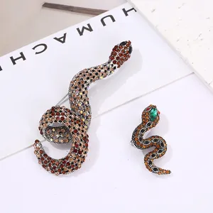 Vintage crystal snake brooch set in gold-tone alloy with amber rhinestones and green accents