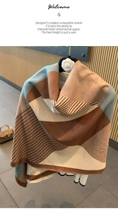 Close-up of cashmere-style scarf showing brown and blue color blocks and fringe details