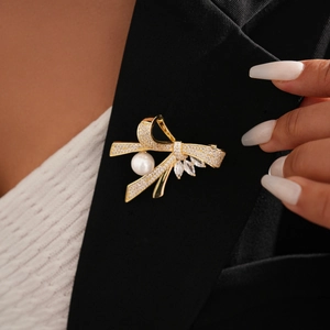 14k gold plated bow brooch with zircon and pearls on a black suit lapel accessory