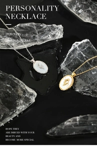 Macro detail of tulip relief on oval shell pendant with gold and silver finishes