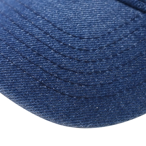 Detailed macro view of the blue denim baseball cap brim with reinforced stitching