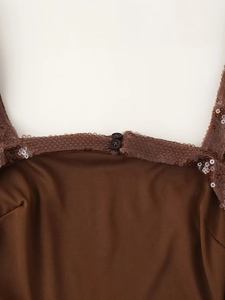 Macro shot of brown sequin collar detail with decorative buttons on an elegant dress