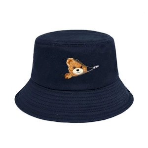 Detail of navy cotton bucket hat featuring a unique zipper pocket with peek-a-boo bear print