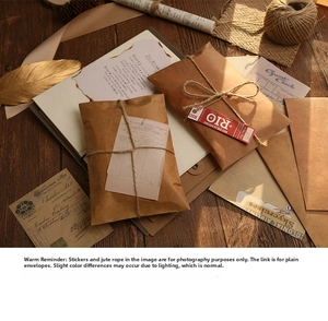 Close-up of vintage brown kraft paper envelopes stacked on a rustic wooden desk with decor