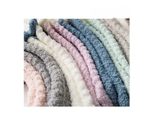 Macro detail of plush coral fleece fabric texture in soft pastel color variants