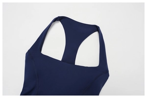 Close-up of racerback design on navy yoga vest showing high-quality stitching