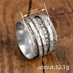 Vintage silver wide ring featuring detailed floral patterns and three rotating inner bands