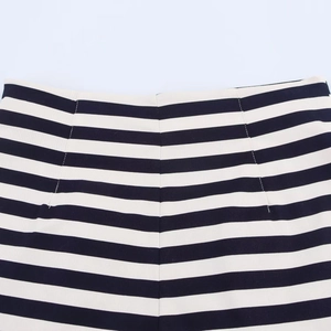Detail of high waisted casual shorts showing black and white stripes and fine stitching
