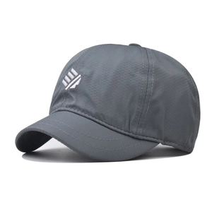 Close-up of breathable honeycomb texture and geometric embroidery on dark gray cap