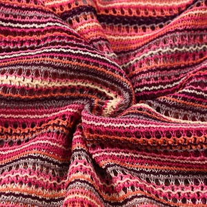 Macro detail of multi-color striped knitted fabric with openwork mesh texture and soft folds