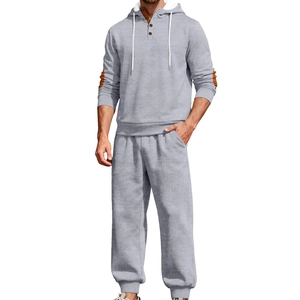 Men's grey hooded tracksuit set featuring unique quilted textured fabric and elbow patches