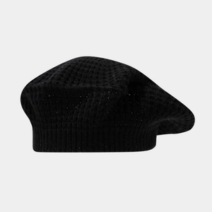 Macro detail of black waffle knit beret showing textured fabric and ribbed edge