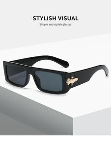 Detail shot of black rectangle sunglasses with vintage gold metal accents on the temples