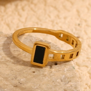 Macro detail of 18K gold plated asymmetric ring with black resin block on stone