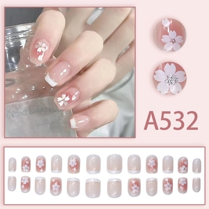 Pink French ombre press-on nails with white cherry blossom patterns and silver glitter