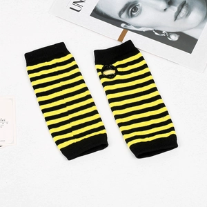 Close-up detail of black and yellow striped knit arm sleeves with fingerless design