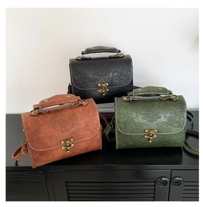 Detailed trio of vintage embossed leather crossbody bags in black, brown, and green