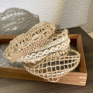 Detailed view of woven linen headbands in natural colors with varied mesh patterns