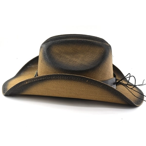 Detail of western straw cowboy hat with distressed black gradient and leather band
