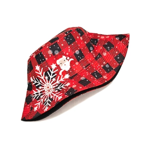 Detailed flat lay of Santa and snowflake patterns on a red buffalo plaid bucket hat