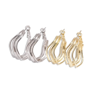 Three-layer irregular wavy hoop earrings in gold and silver finish with metallic texture