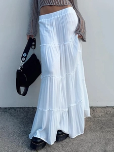 Chic white tiered maxi skirt featuring elastic waist and elegant layered fabric design