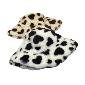 Detail of soft fuzzy bucket hats with black and brown heart-shaped cow prints