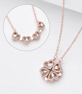 Macro detail of convertible four-leaf clover necklace with rose gold diamond hearts