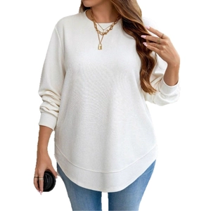 Macro shot of white waffle knit texture and curved hem on elegant women long sleeve top