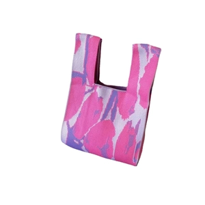 Minimalist knit tote bag with pink and purple abstract patterns on white background