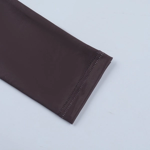 Detail of sleeve cuff stitching on a dark brown sexy deep V-neck long sleeve dress