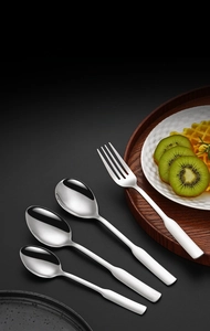 Polished 304 stainless steel spoons and fork set on a dark textured background