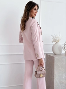 Detail of pink double-breasted blazer showing tailored back cut and premium fabric texture
