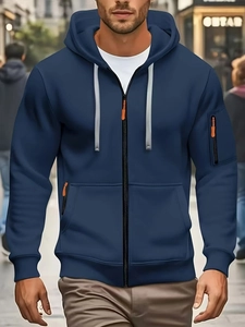 Detail of navy blue zip-up hoodie with grey drawstrings and orange zipper accent
