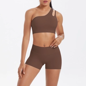 Close-up of brown one-shoulder sports bra with cutout detail and high-waist yoga shorts