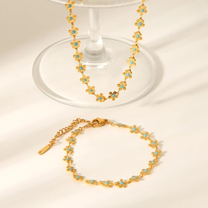 Detail of 18K gold plated stainless steel flower necklace and bracelet with turquoise enamel