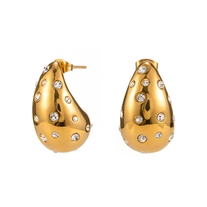 Boucles d'oreilles dorées en forme de goutte creuse avec cristaux blancs étincelants
