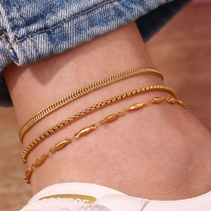Detailed view of three layered 18K gold plated stainless steel anklet chains on ankle