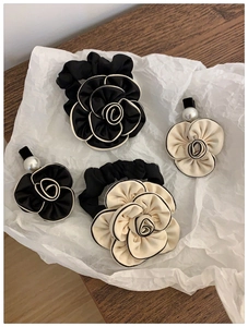 Detailed set of camellia hair scrunchies and pearl clips in black and white silk fabric
