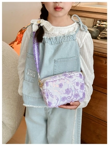 Detail view of purple floral girls' crossbody bag with sequins and lace strap