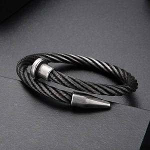 Detail view of black twisted wire nail bracelet with industrial vintage texture
