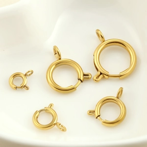 Macro shot of gold-plated stainless steel spring ring clasps in five sizes for DIY jewelry