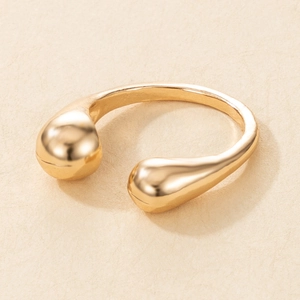 Minimalist golden teardrop open ring with high-polish finish in a 45-degree top view