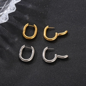 U-shaped stainless steel earrings in gold and silver finish shown on a dark background