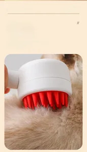 Detail of a white mouse-shaped pet bath brush with soft red silicone bristles on fur