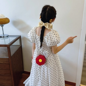 Cute red sunflower toddler shoulder bag with chain strap shown on a model in polka dot dress