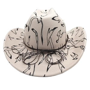 Detail of wide brim cowboy hat in beige featuring all-over black swallow bird print